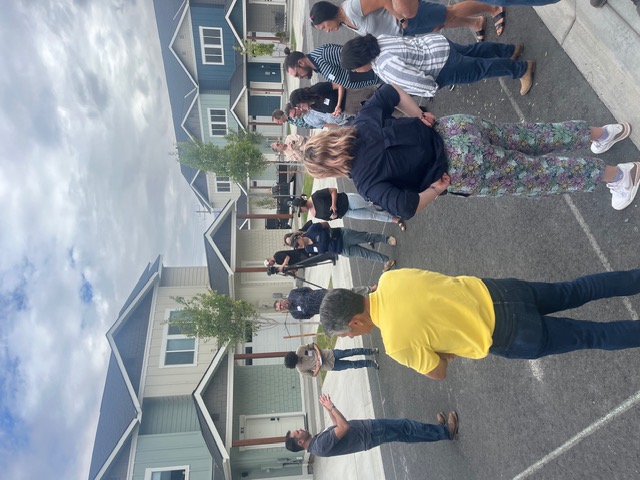 Building NCW members gathered and talking in front of townhomes