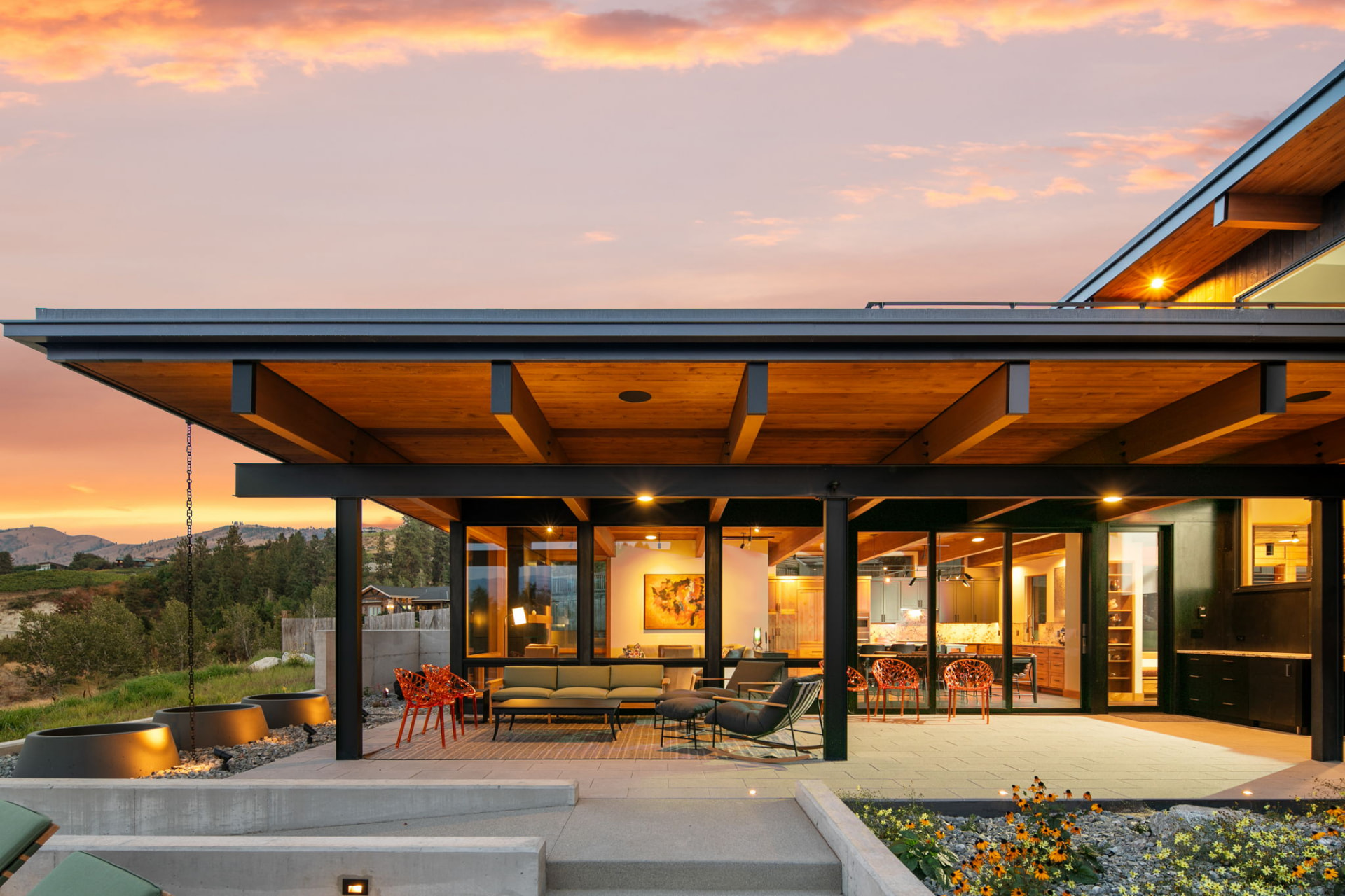 North Central Washington home with warm wood ceilings and a covered patio at sunset